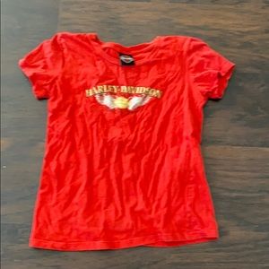 A red Harley Davidson with a brand picture front